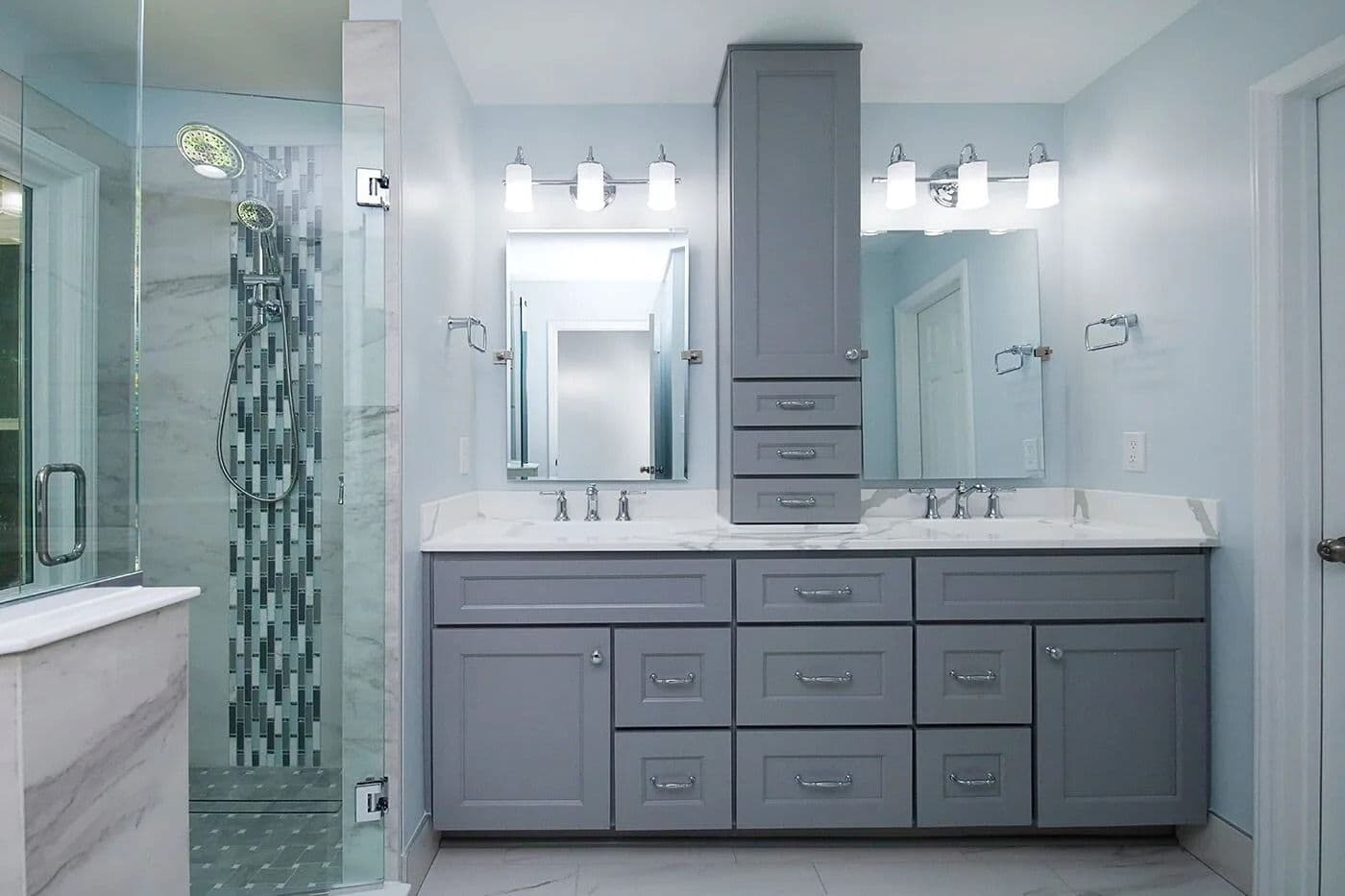 A newly-remodeled bathroom by EZPro Kitchen & Baths with double vanity and gray cabinets.
