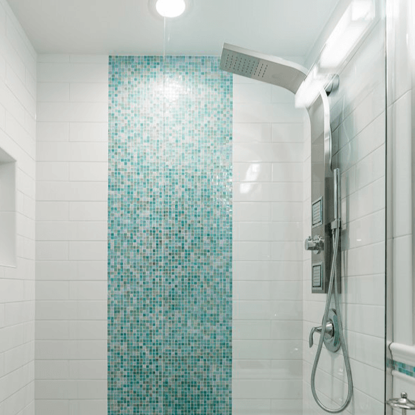A custom rain showerhead in a shower with blue mosaic tile accent wall.