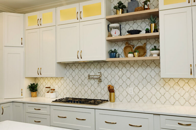 White kitchen remodel in Cary, NC with arabesque tile backsplash and gold hardware